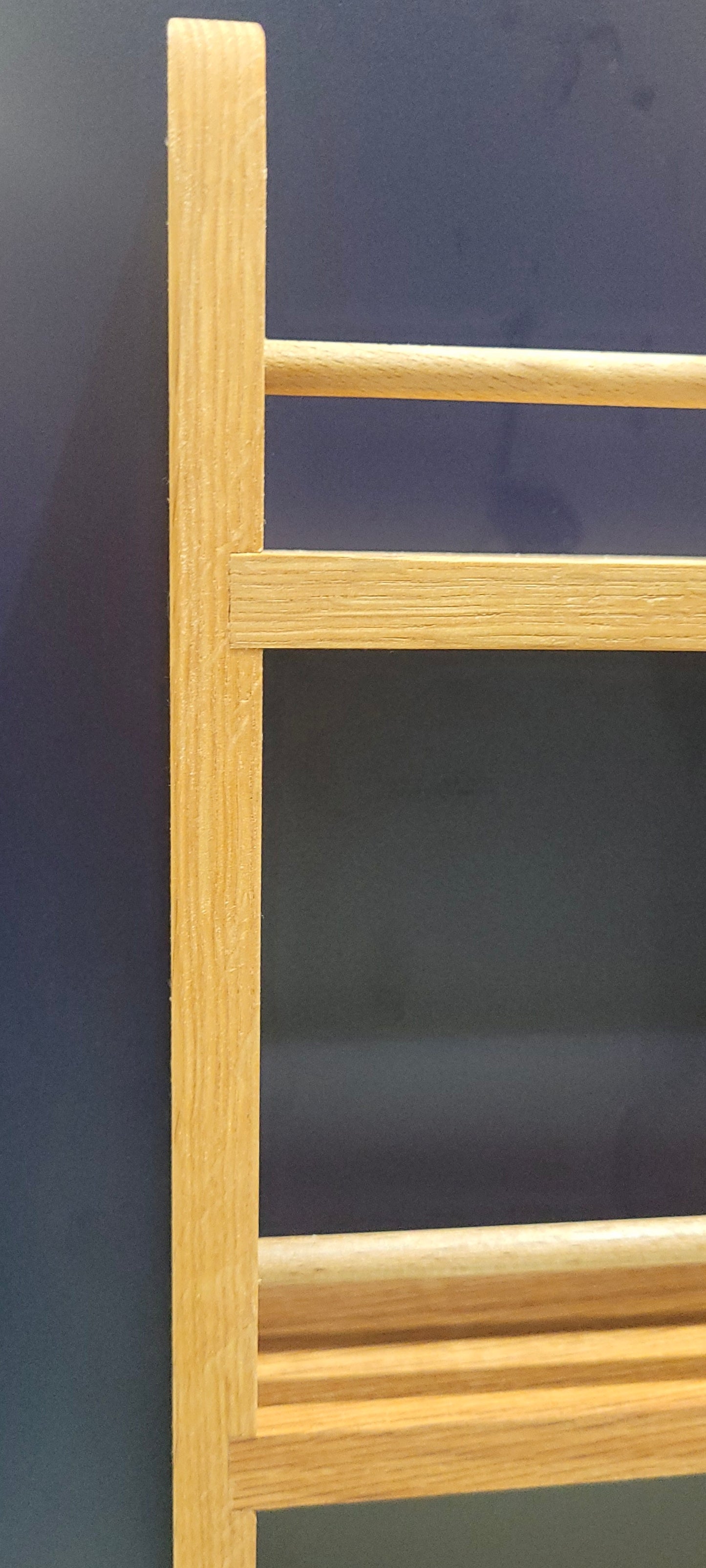 Closeup of 3 shelf solid oak spice rack for cupboard door hanging