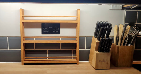 Solid oak spice rack with 3 shelves on a kitchen worktop