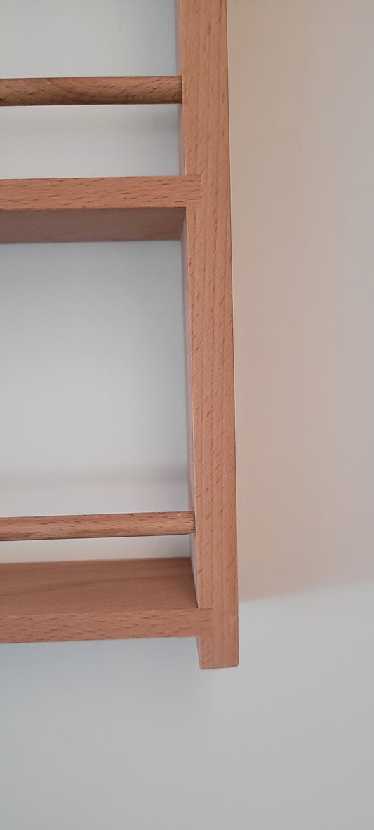 Close up of wooden dowels on solid beech door spice rack