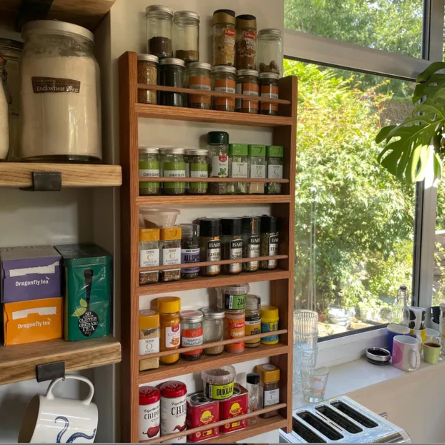 Solid oak 5 shelf spice rack with lots of spice and herb jars
