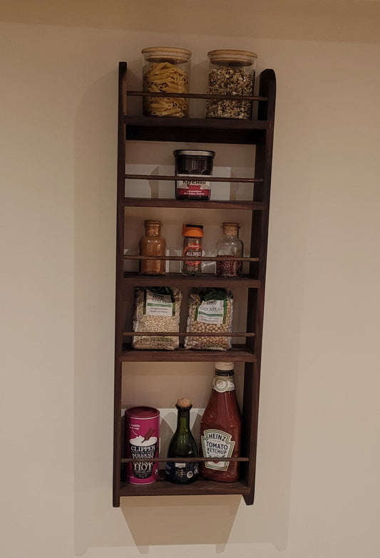 A walnut spice rack designed for a larder or pantry cupboard, with 4 spice shelves and a tall bottle shelf.